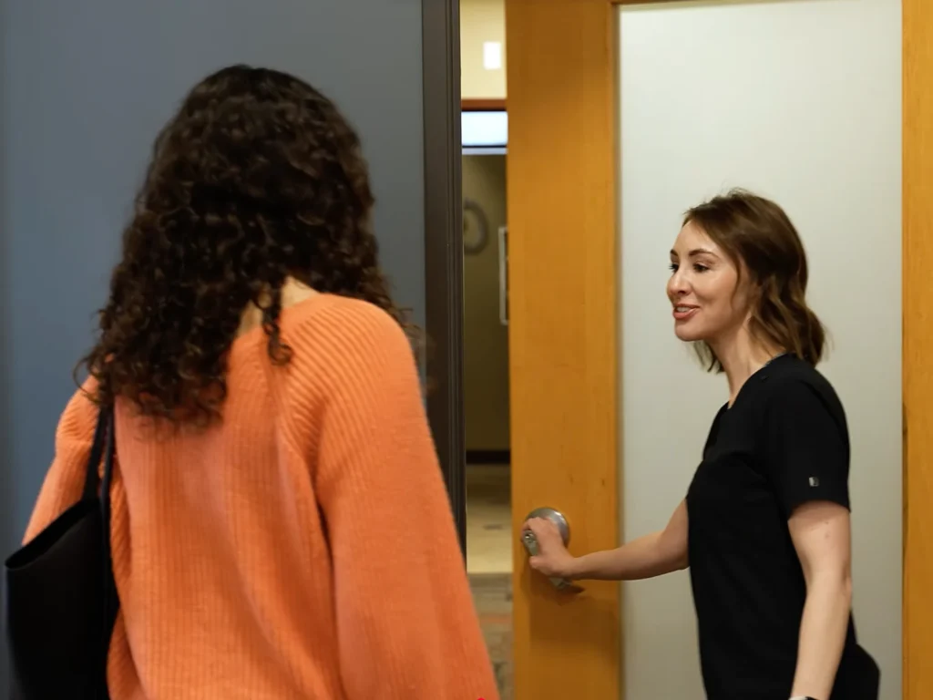 A team member escorts the patient to a private exam room